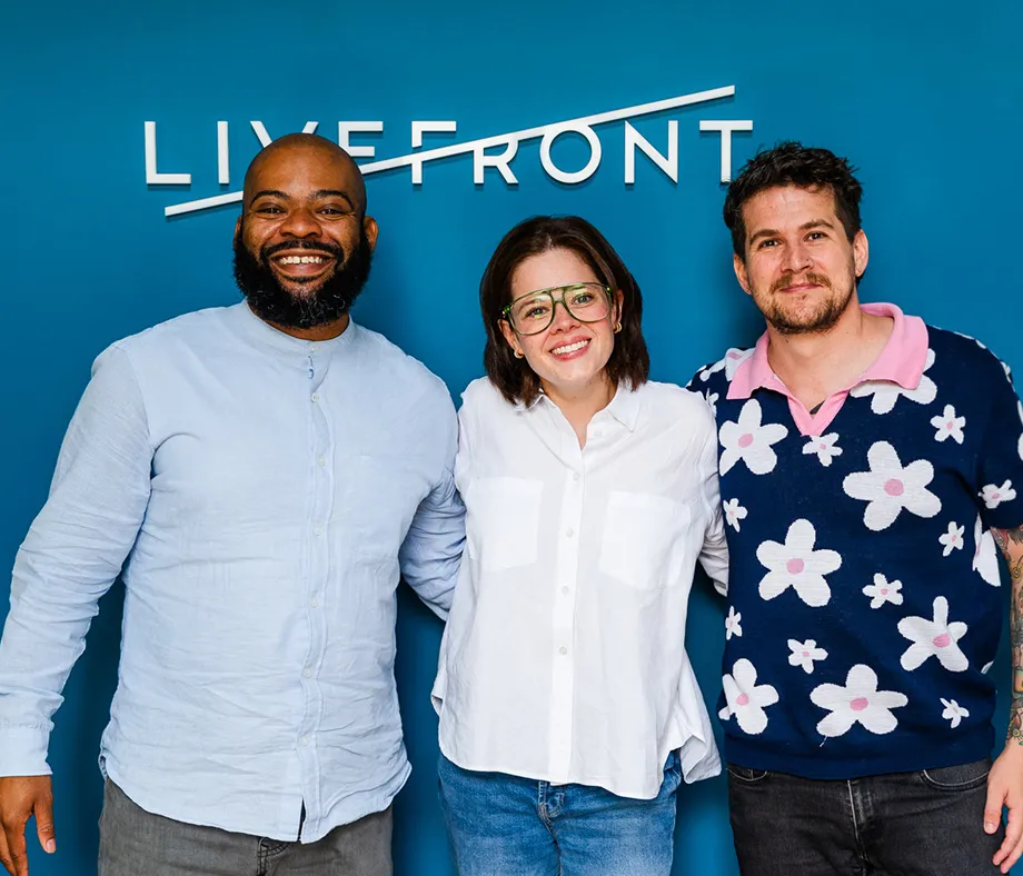 Group of people sitting around a table with laptops